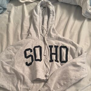 Garage cropped zip up jacket. It says SOHO.